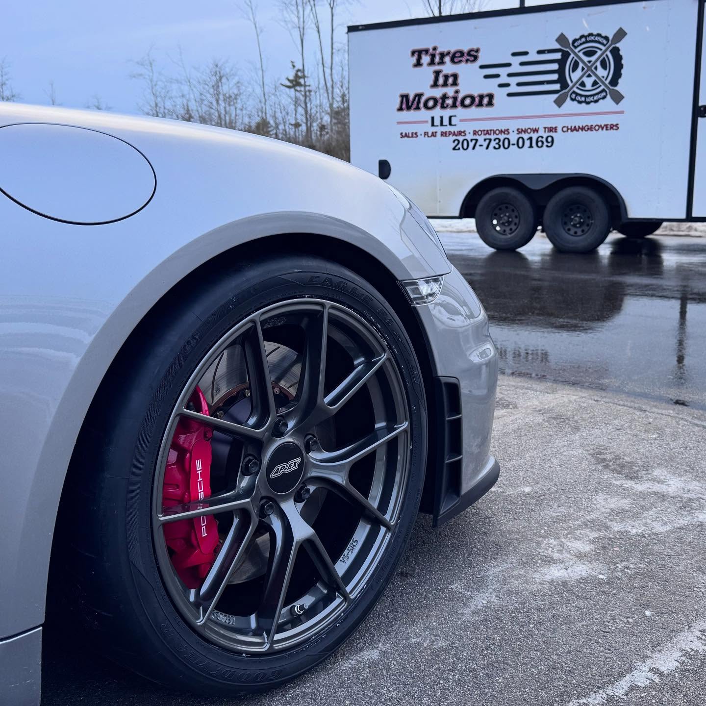 Porsche with APEX wheels alongside the Tires in Motion mobile shop